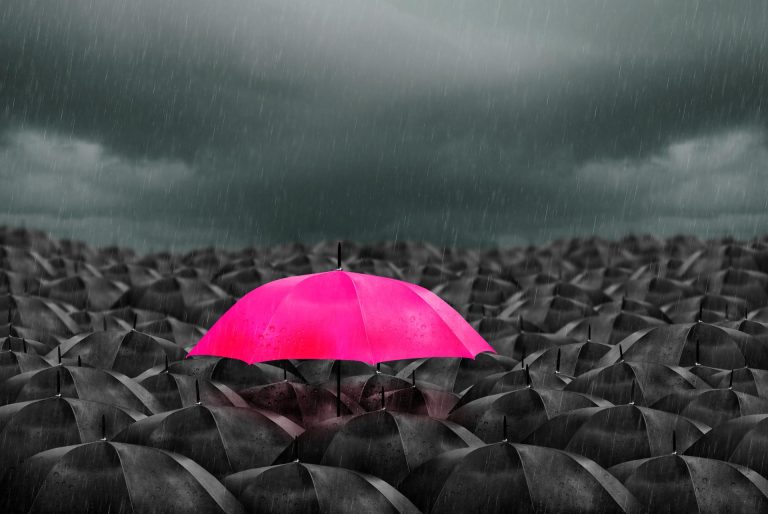 parapluie rose au milieu de parapuie noir